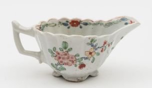 A rare early Worcester small creamboat: the ribbed body with flared lip and angular handle,