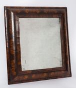 An early 18th Century walnut oyster veneer cushion frieze rectangular mirror:,
