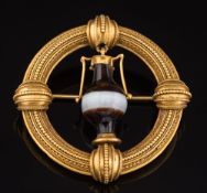 A 19th century gold and agate circular brooch: with central urn-shaped banded agate drop suspended