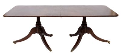 A mahogany twin pillar dining table in the Regency taste:,
