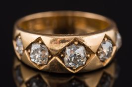 An 18ct gold and graduated diamond five stone ring: with cushion shaped diamonds estimated to weigh