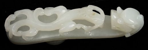 A Chinese carved white jade dragon belt hook: with dragon's head terminal,