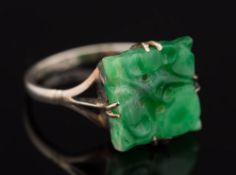 A pierced jade square panel mounted ring: the shank stamped '9ct', ring size N.