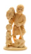 A Japanese carved ivory okimono of a farmer and child: the farmer holding a cockerel in one hand