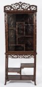 A Chinese carved hardwood and simulated bamboo decorated display cabinet on stand:,