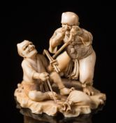 A Japanese okimono of two demons:, Meiji period (1864-1912), one standing and stringing a bow,