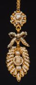 A gold and seed pearl cannetille pendant: of open work design, on 9ct gold fine-link chain,