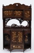 A late 19th Century Japanese Shibyama decorated wall cabinet:, with flowering trees,