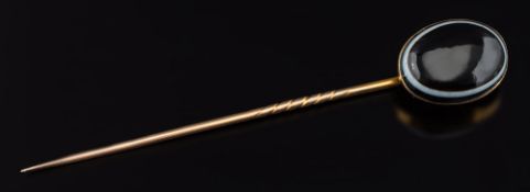 An oval banded agate single stone stick pin: the oval agate 20mm long x 15mm wide with closed back