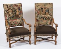 A pair of carved walnut and beech open armchairs in the 17th Century taste:,