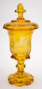 A Bohemian amber flashed goblet and cover: of octagonally faceted form with knopped stem and petal