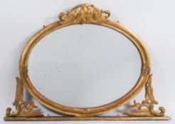 A Victorian carved giltwood and gesso oval overmantel mirror:,