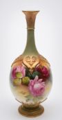 A Royal Worcester porcelain vase: of tear drop form with raised strap work to the shoulders and