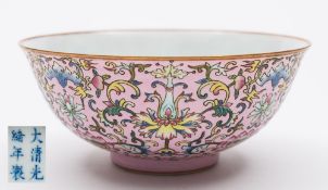 A Chinese porcelain bowl: the exterior decorated in the famille rose palette with lotus and peony
