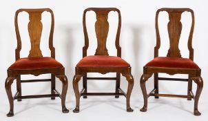 A set of eight walnut dining chairs in the George I manner:,