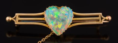 A heart shaped opal mounted bar brooch: the heart shaped opal approximately 14.9mm wide x 15.