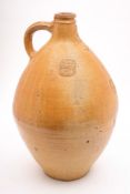 A large salt glazed stoneware Bellarmine or Bartmann krug: of typical bellied form with ribbed