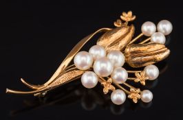 A cultured pearl mounted spray brooch: with twelve graduated cultured pearls the reverse stamped