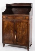 An early 19th Century mahogany chiffonier:, of small size with a shaped and shelved superstructure,