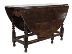 An 18th Century oak oval gateleg table:, with a hinged top,