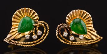 A pair of jade and diamond mounted heart-shaped clip earrings: each with a pear shaped jade and