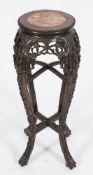 A Chinese carved wood circular jardiniere stand:, the top with a beaded edge,