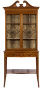 An Edwardian mahogany and marquetry display cabinet:, on a serpentine fronted stand,