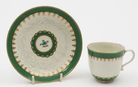 A Worcester apple green 'Chrysanthemum' pattern cup and saucer: with moulded chrysanthemum flowers