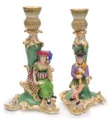 A pair of English porcelain figural candlesticks, probably Minton: modelled with Scottish musicians,