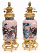 A pair of 20th century Chinese cloisonne and gilt metal table lamps: decorated with figures dancing