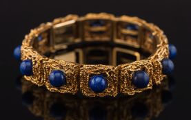 A French gold and lapis lazuli rectangular-link bracelet: of textured design,