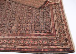 A Fereghan runner:, the indigo field with all over designs enclosed by a multiple border,