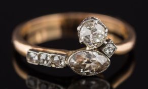 An 18ct gold and diamond six stone ring: with marquise-cut and cushion-shaped diamonds estimated to