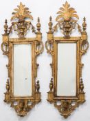 A pair of 19th Century Continental carved giltwood mirrors:, of small size,