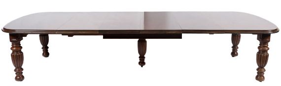A Victorian mahogany extending dining table:, the top with a moulded edge and curved leaves,