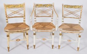 A set of five white and gilt decorated occasional chairs in the Regency taste:,