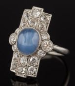 An art deco star sapphire and diamond rectangular cluster ring: with central oval star sapphire