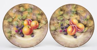 A pair of Royal Worcester porcelain fruit decorated plates: of circular form painted by Nigel Creed