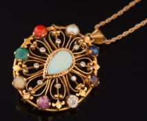 A multi gem-set oval pendant/brooch of pierced design: with central pear shaped opal within a