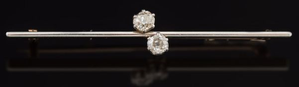 A diamond two stone bar brooch: stamped '15ct & PT' with circular old brilliant-cut diamonds
