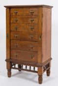 An Aesthetic movement oak Wellington chest:,