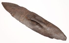 An Australian Aboriginal parrying shield: of traditional oval form with incised geometric banded