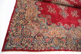 A Meshed carpet:, the red cartouche field with a central indigo,