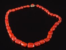 A graduated coral bead single-string necklace: with 38 irregular beads graduated from 10mm long to