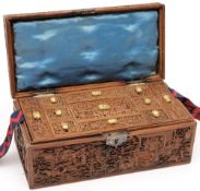 A Chinese carved sandalwood rectangular box: finely carved with figures by pavillions and in garden