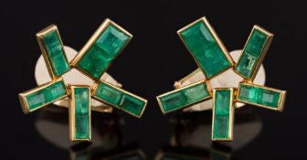 A pair of stylized emerald clip earrings: each with rectangular-cut emeralds and stamped '14K',