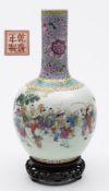 A Chinese porcelain bottle vase: enamelled in the famille rose palette with a procession of