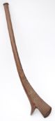 A Fijian war club of gun-stock type: the blade with incised geometric decoration, on a curved shaft,