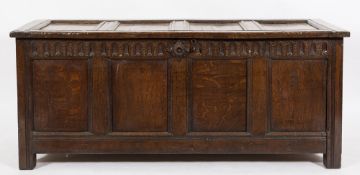 An early 18th Century oak rectangular coffer:, of moulded panel construction, with a hinged top,