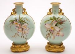 A pair of Minton porcelain moon flasks: of Japonesque flattened circular form on a pierced gilt